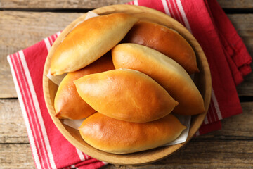 Tasty baked patties on wooden table, top view