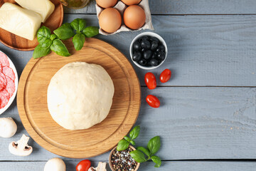 Making pizza. Different ingredients on gray wooden table, flat lay. Space for text