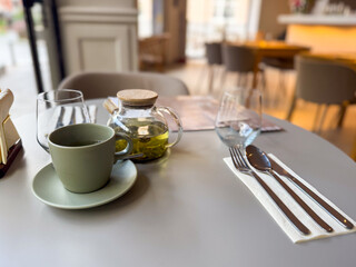 Minimalist cafe tea setting with a focus on herbal tea. Slow living, clarity and simplicity during a midday break.
