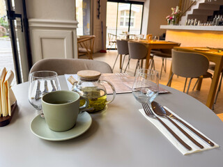 Hot green tea served at a cozy urban cafe table. Moment of pause, flavor and quiet enjoyment in the city