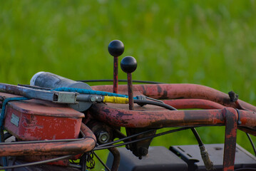 Enhance your farming efficiency with this sturdy red lawn mower, set against a lush green pasture. Its vibrant design and reliable performance embody practicality and style.