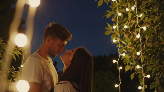 Romantic couple moment under string lights at night for love and engagement videos and wedding content video 4k uhd