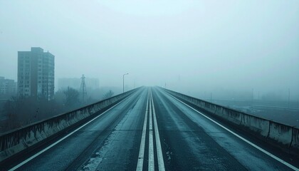 Fototapeta premium Empty elevated freeway vanishing into dense early morning fog