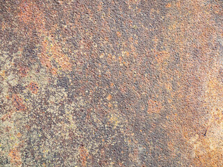Rusty metal texture background with weathered surface and orange tones.