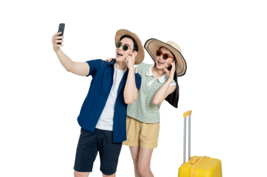 portrait of asian couple wearing travel clothes, suitcases and using phone posing on background	
