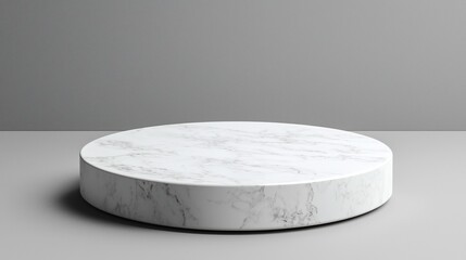 Round marble display platform on grey background; product presentation