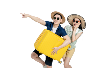portrait of asian couple wearing travel clothes, carrying suitcases and posing on white background