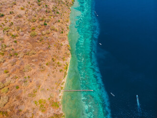 Coastline with diving sites in transparent ocean on Menjangan, Bali. Aerial view