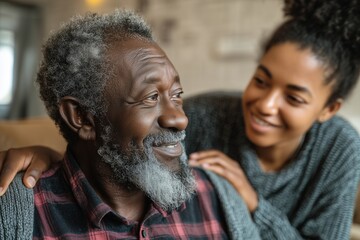 Elderly African man being assisted by a caring young caregiver in a home environment, concept of compassion and support.