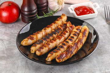 Grilled meat sausages wrapped bacon