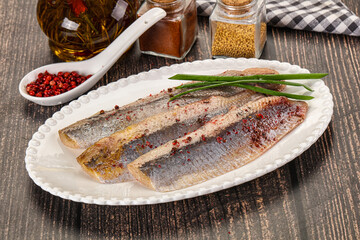 Salted marinated herring fillet with spices