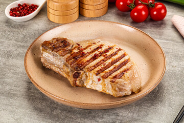 Grilled pork loin steak with bone