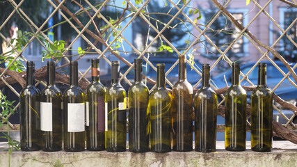Wine bottles in a row on the fence