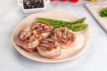 Tasty grilled pork medallion with bacon