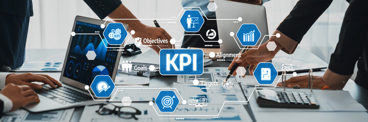 Collaborative Team Meeting Focusing on Key Performance Indicators, Goal Setting, and Business Objectives in a Modern Office Environment. Amity