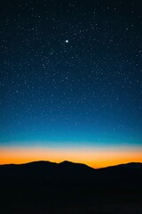 Obraz premium Night Sky over Silhouetted Mountains