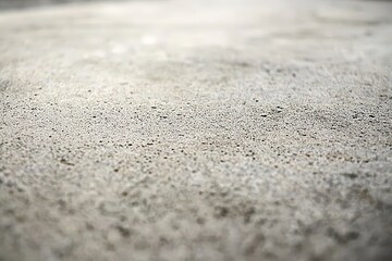 Close-up view of a light gray concrete surface texture.
