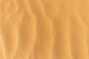Sand summer smooth texture. Close up of sand wave dune background. Copy space for text. Top view.