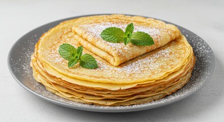Stack of pancakes with mint isolated on white background