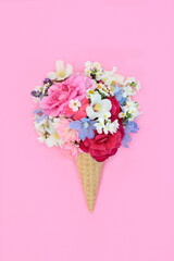 Surreal summer flowers ice cream cornet on pink background. Whimsical surreal abstract edible quirky fun food art design for greeting card.