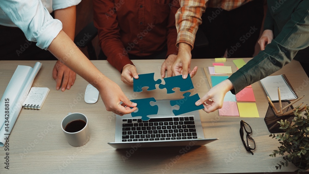Aufkleber a dynamic scene showcasing teamwork with hands assembling puzzle pieces over a laptop in an inviting
