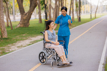 A devoted female physician lovingly cares for her elderly wheelchair-bound patient, offering...