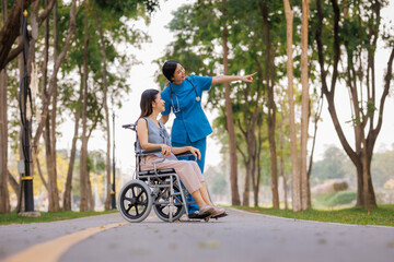 A devoted female physician lovingly cares for her elderly wheelchair-bound patient, offering...