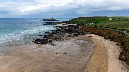 Drone captures South England’s raw beauty with cliffs, stones, green pastures, and a lonely island lighthouse.