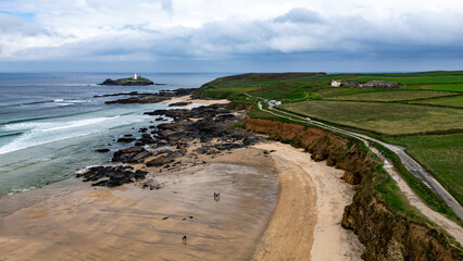 Dramatic cliffs, rolling green fields, rocky shores, and an isolated lighthouse off South England’s beautiful coast.
