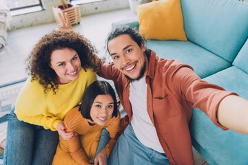 Group of friends enjoying cheerful moments together indoors, illustrating casual lifestyle and diversity in a vibrant home