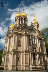 Russian Orthodox church with golden domes in the German city of Wiesbaden. Against the blue sky with clouds
