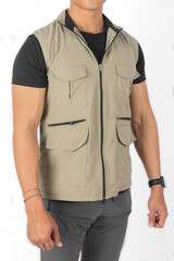 Young Asian man wearing beige vest jacket with many pockets