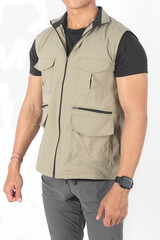 Young Asian man wearing beige vest jacket with many pockets