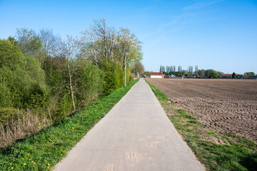 Cycling path through the woods and agriculture fields in Comines - Warneton, Hainaut, Belgium