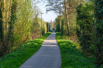 Cycling path through the woods and agriculture fields in Comines - Warneton, Hainaut, Belgium