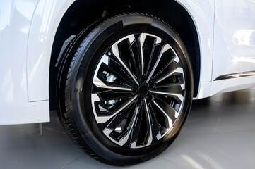 Car wheel with brake calipers and stylish design.