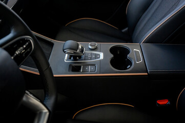 Automatic transmission selector in the interior of a modern car.