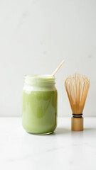 A smoothie jar with a bamboo strainer for keto diet smoothies on a white marble countertop.