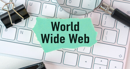 A keyboard with a piece of paper that says World Wide Web on it