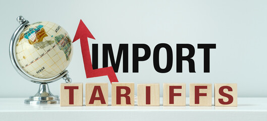 A globe is on a table with the word Import Tariffs written below it