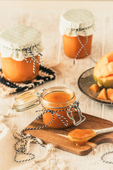 Homemade mango jam on white wooden table