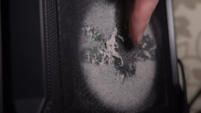 Technician showing dust accumulation on computer fan