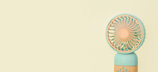 Mini electric fan on color background, closeup