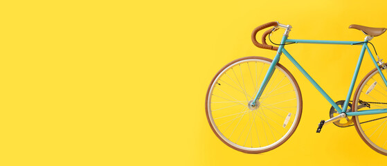 Stylish bicycle on yellow background