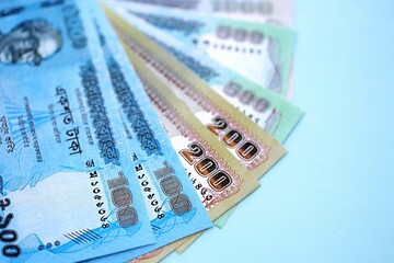 Bangladeshi taka money bills in big amount lies on teal color table close up