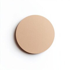A circular, light brown, textured object with a subtle shadow against a white background