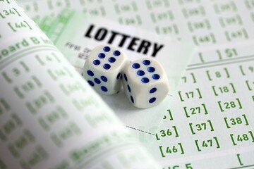 Lottery tickets and dice on blank bills with numbers for playing lottery