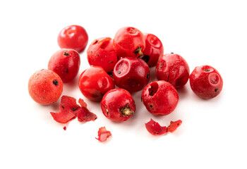 Pink peppercorns isolated on white background. Pile of pink peppers macro.
