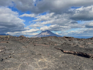 Lava fields with a volcano in the background