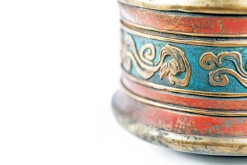 Close-up of an ornate, antique Tibetan prayer wheel with intricate designs and a weathered finish.